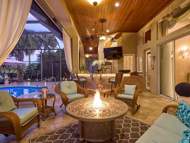 a outdoor living space with furniture and a chandelier