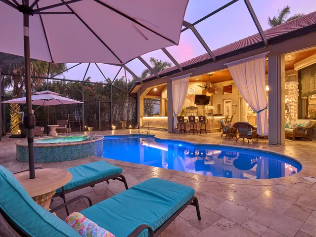 a view of balcony with furniture and umbrella