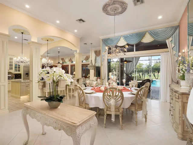 a living room with furniture a chandelier and a large window