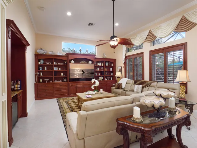 a kitchen with stainless steel appliances kitchen island granite countertop a refrigerator a stove top oven a sink dishwasher and white cabinets with wooden floor