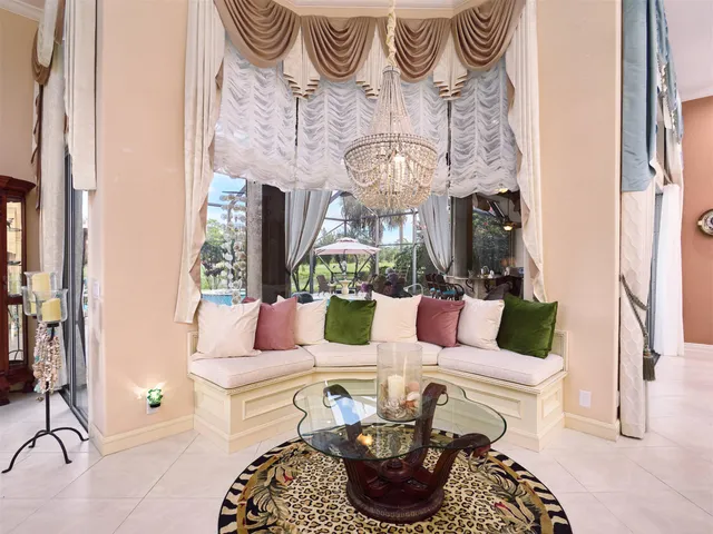 a living room with furniture chandelier and fireplace