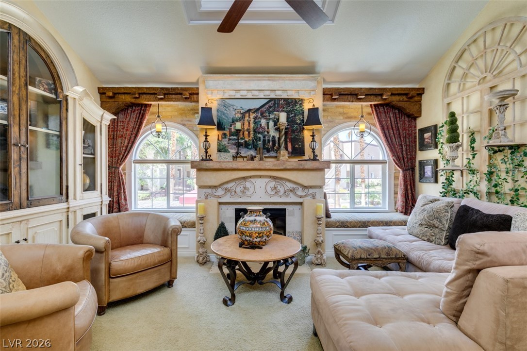 9325 West Desert Inn Road, Unit 244 Las Vegas, NV 89117 - Photo 6 of 55 Ornate fireplace with intricate detailing anchors this inviting living space, framed by large arched windows.
