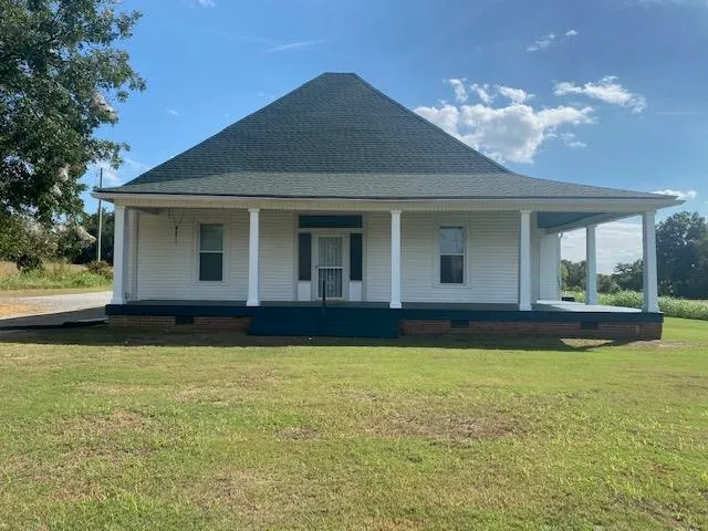 a view of a house with swimming pool and sitting area