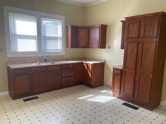 a kitchen with stainless steel appliances granite countertop a refrigerator a sink and wooden cabinets