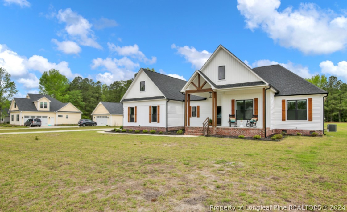 5621 Toby Pl Road Stedman, NC 28391 - Photo 3 of 38 a front view of a house with a garden and yard