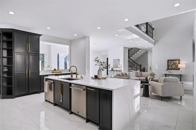 a kitchen with stainless steel appliances granite countertop a refrigerator and a sink