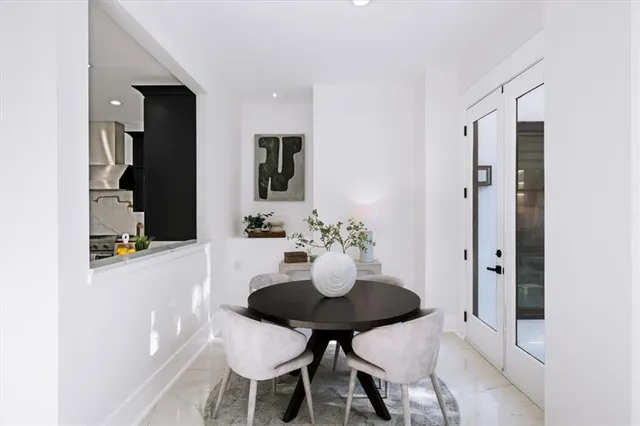 a spacious bedroom with a bed and a flat screen television