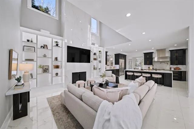 a living room with furniture a fireplace and a flat screen tv