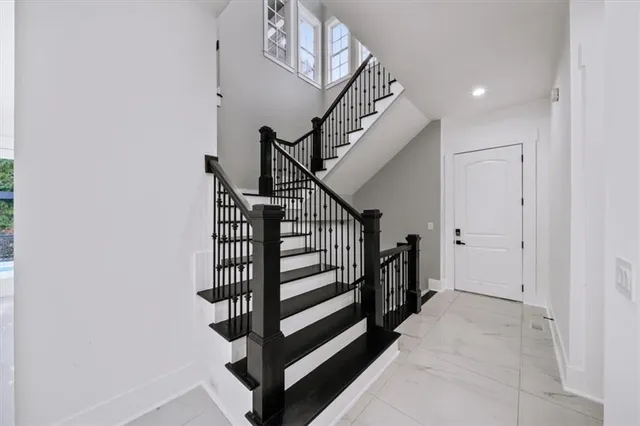 a bathroom with a granite countertop sink mirror and a bathtub