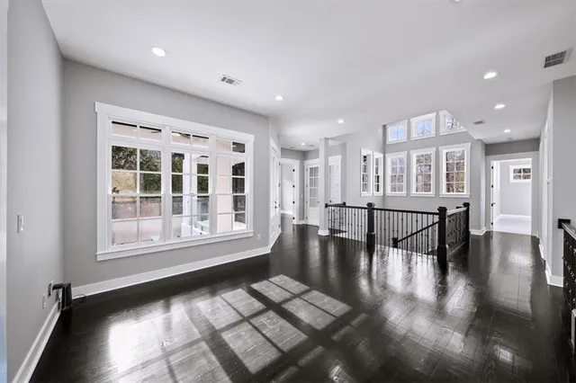 a view of a livingroom with wooden floor and a ceiling fan