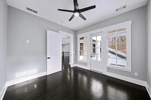 a view of a hallway with wooden floor