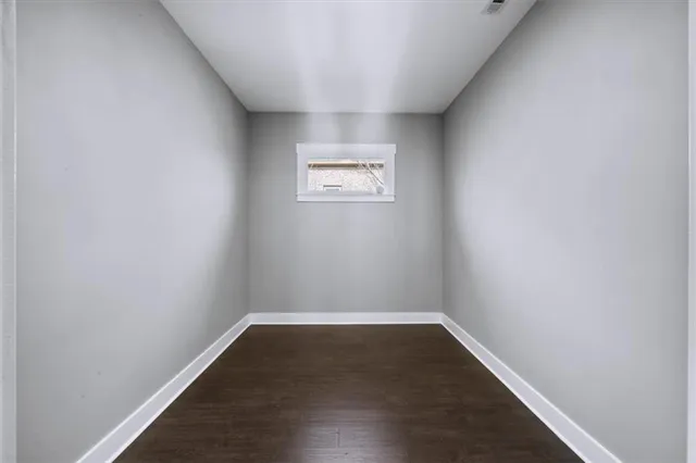 a living room with a large window and a fireplace