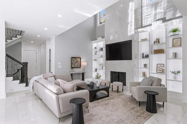 a living room with furniture a fireplace and a flat screen tv