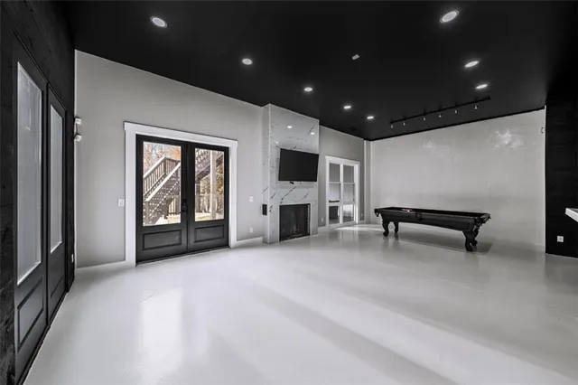 a view of a house with pool and sitting area