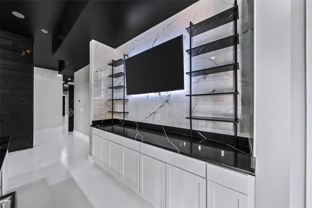 an empty room with closet and windows