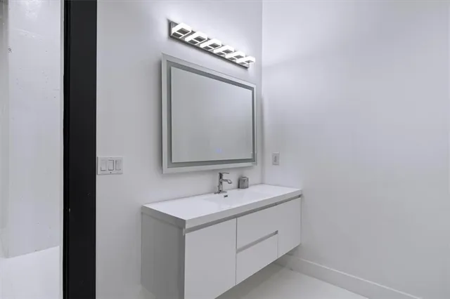 a view of a house with a small yard and wooden deck