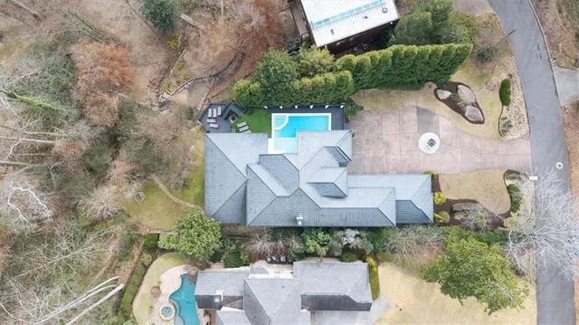 a view of small yard with large trees