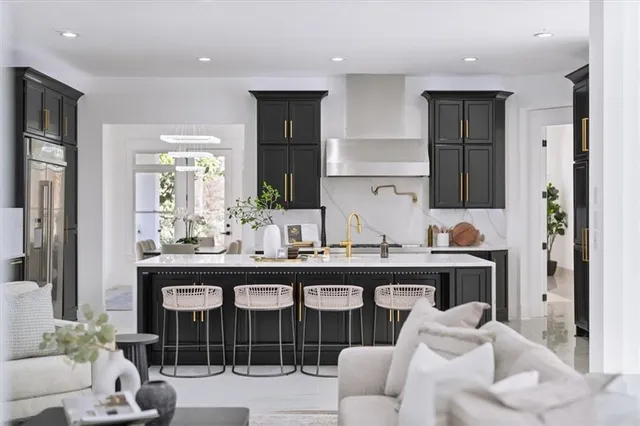 a living room with furniture a chandelier and a table