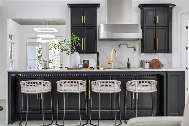 a kitchen with stainless steel appliances a stove microwave and refrigerator