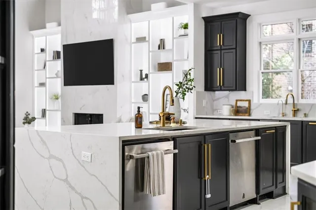 a kitchen with stainless steel appliances granite countertop a sink and a refrigerator