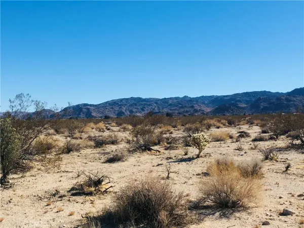 a view of a large mountain with mountains in the background