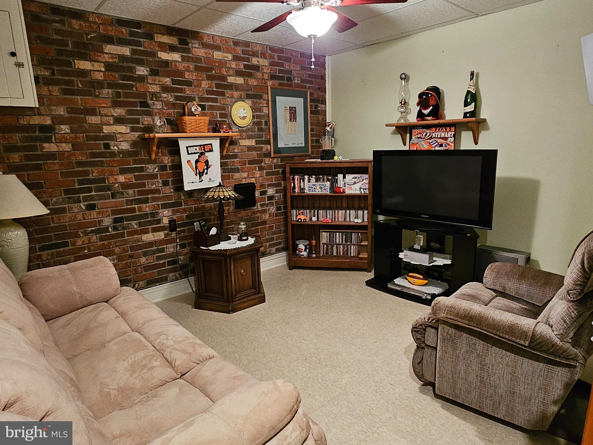 633 Medway Road Hagerstown, MD 21740 - Photo 23 of 29 finished family room with real brick accent wall