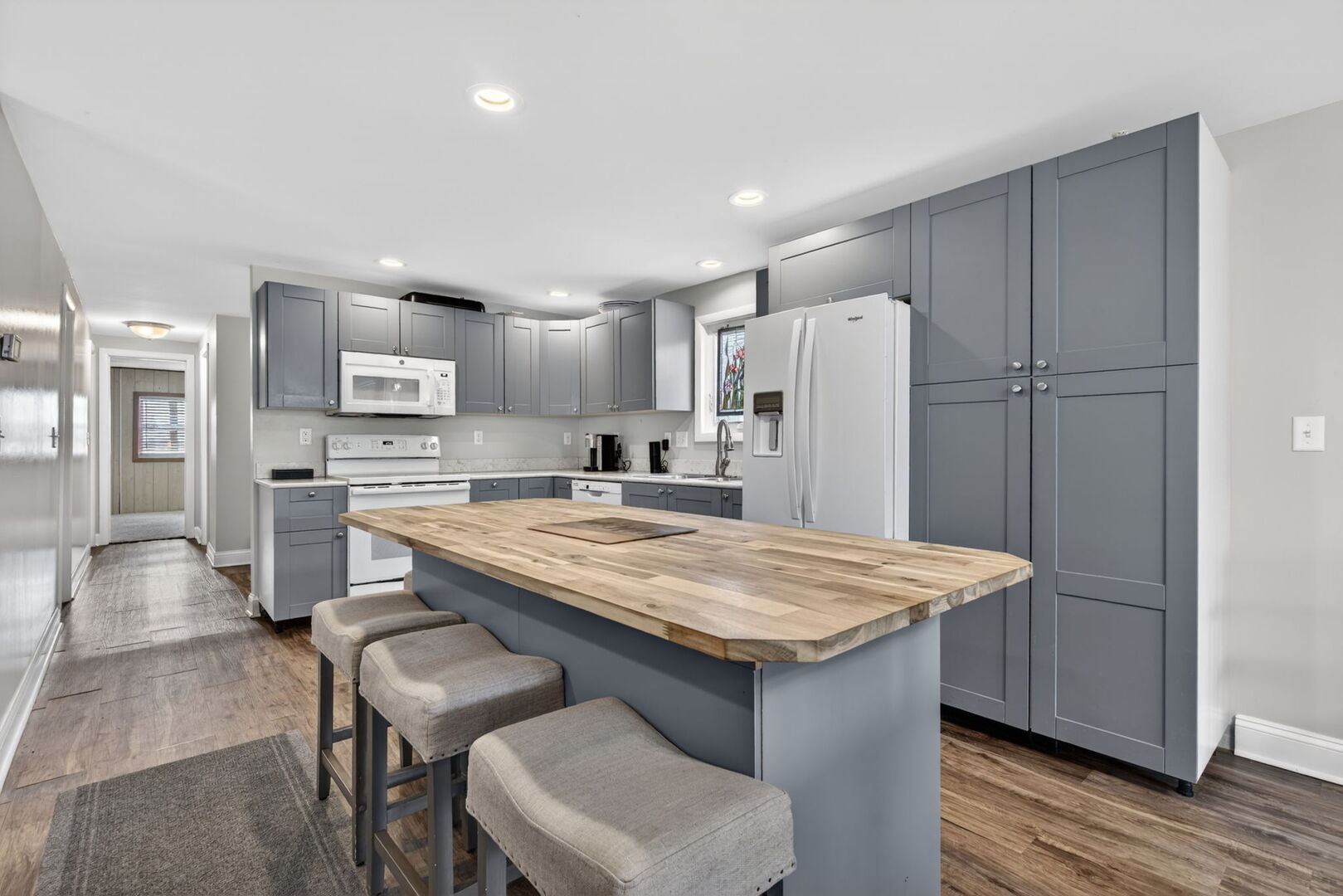 18530 West 3000 N Road, Unit 173 173 Reddick, IL 60961 - Photo 11 of 39 a kitchen with stainless steel appliances granite countertop a table chairs sink refrigerator and cabinets