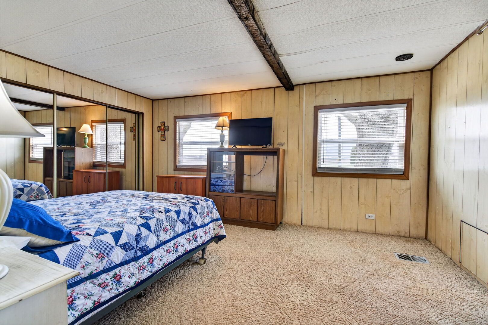18530 West 3000 N Road, Unit 173 173 Reddick, IL 60961 - Photo 2 of 39 a bedroom with a large bed and a dresser