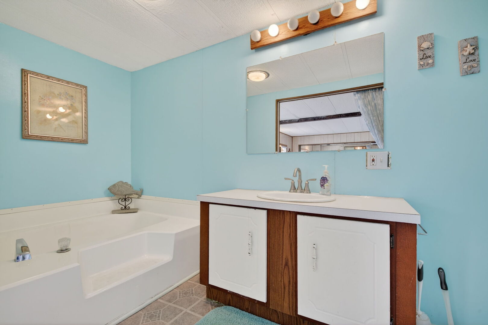 18530 West 3000 N Road, Unit 173 173 Reddick, IL 60961 - Photo 5 of 39 a bathroom with a sink a mirror and vanity