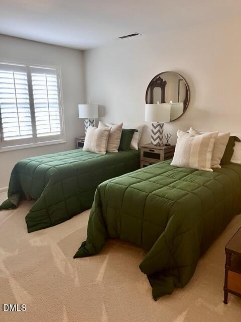 7601 Astoria Place Raleigh, NC 27612 - Photo 13 of 30 a bedroom with a bed and a large mirror