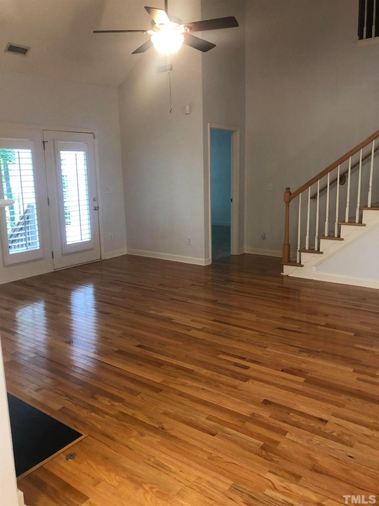7601 Astoria Place Raleigh, NC 27612 - Photo 20 of 30 a view of an empty room with wooden floor and a window