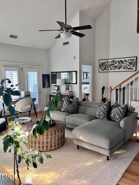 7601 Astoria Place Raleigh, NC 27612 - Photo 2 of 30 a living room with furniture a chandelier and a potted plant