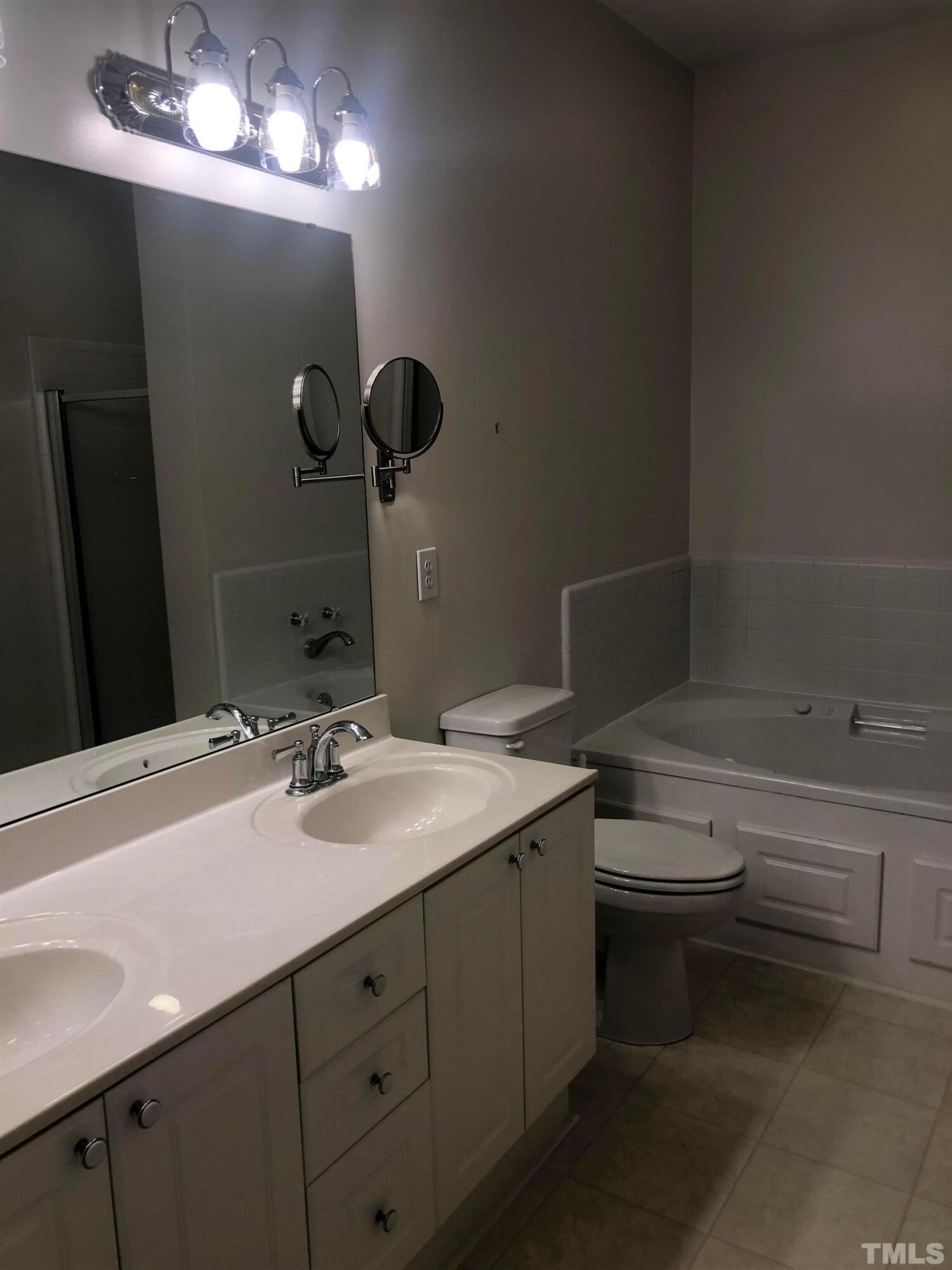 7601 Astoria Place Raleigh, NC 27612 - Photo 26 of 30 a bathroom with a sink vanity and toilet