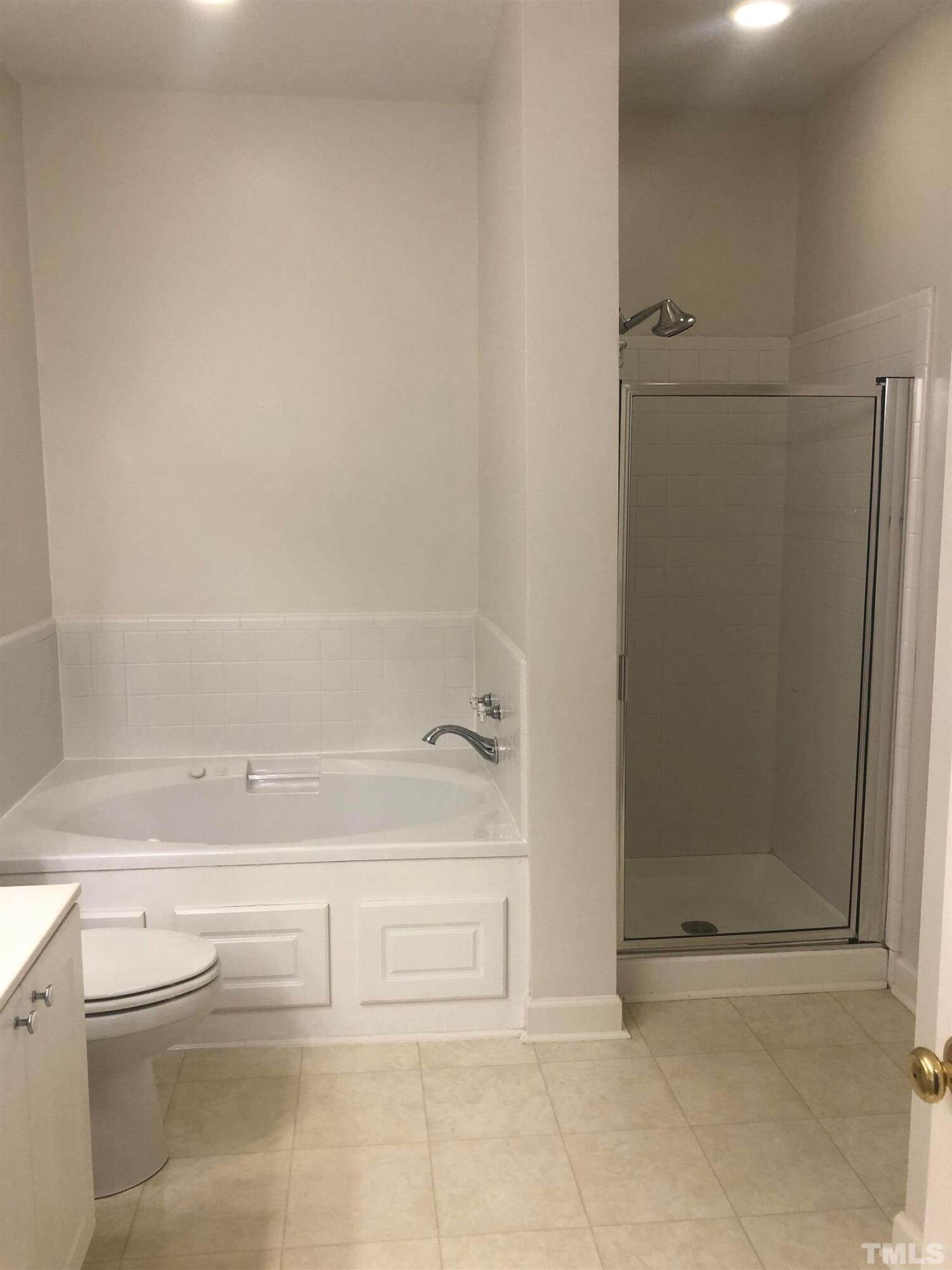 7601 Astoria Place Raleigh, NC 27612 - Photo 27 of 30 a bathroom with a bathtub