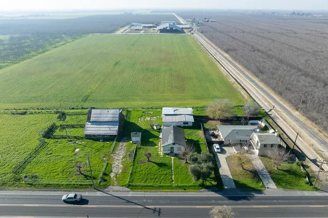 an aerial view of residential houses with outdoor space and river
