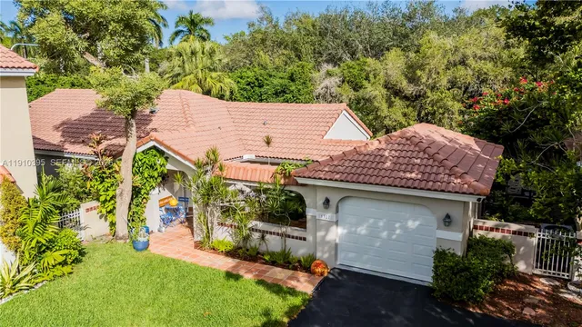 aerial view of a house with a yard and potted plants