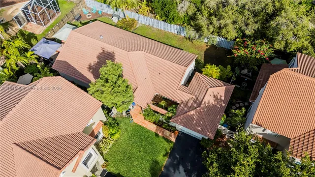 an aerial view of a house with a yard and trees