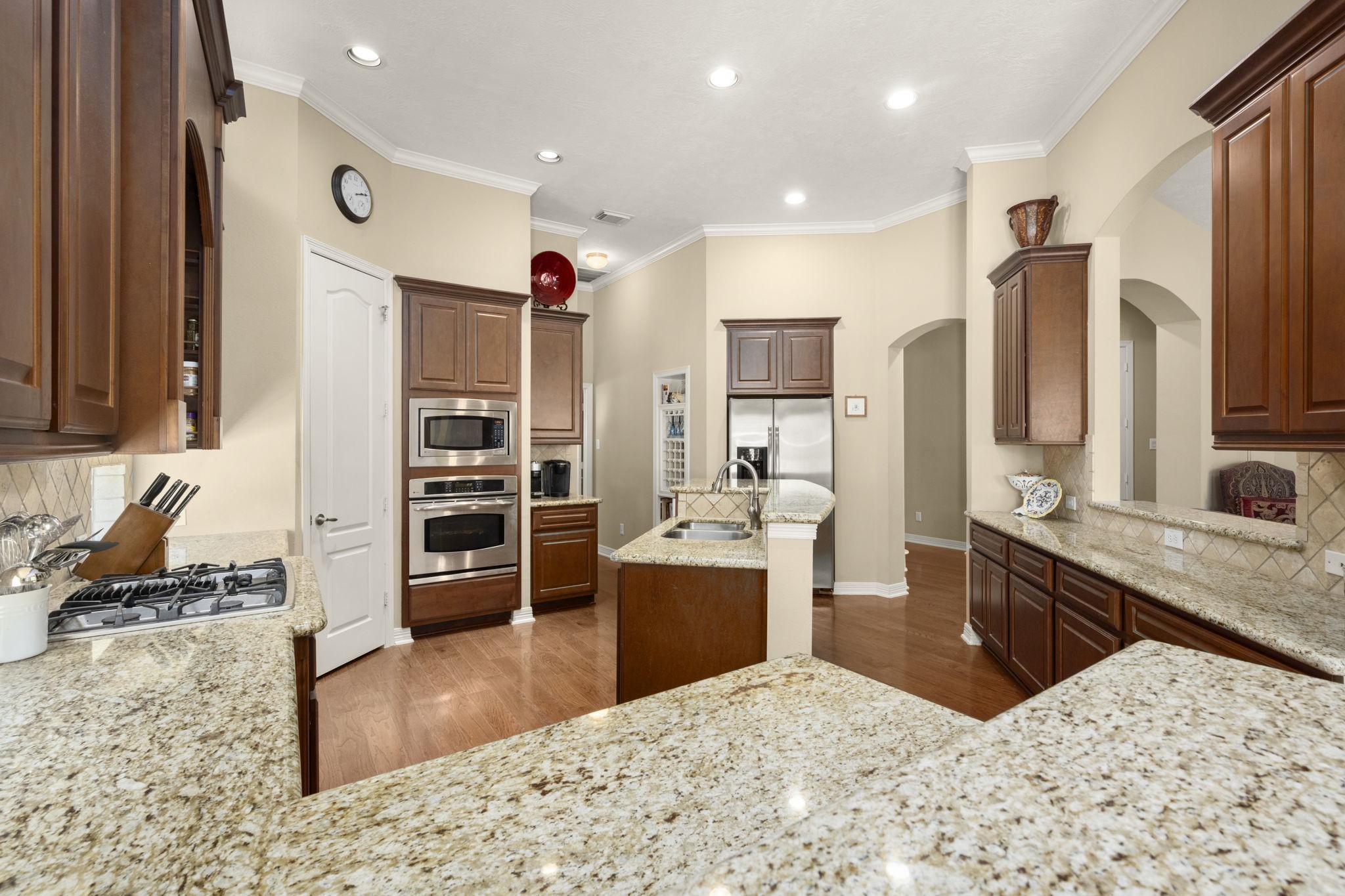 19902 Tidy Tips Lane Spring, TX 77379 - Photo 20 of 49 a kitchen with stainless steel appliances kitchen island granite countertop a refrigerator and a sink
