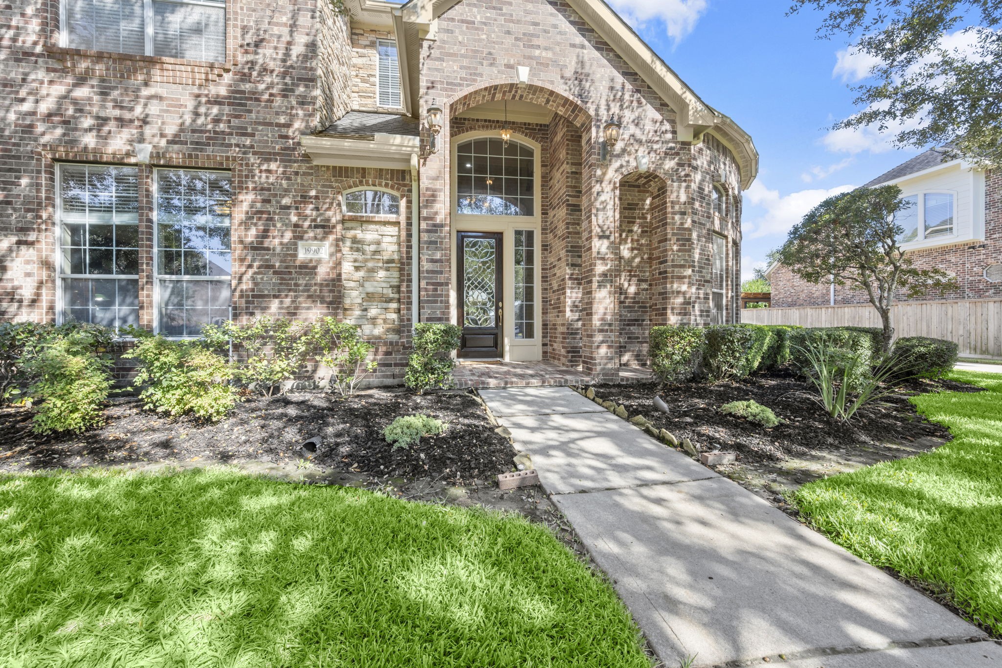 19902 Tidy Tips Lane Spring, TX 77379 - Photo 32 of 49 a front view of a house with garden