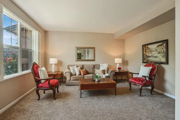 a dining room with furniture and window