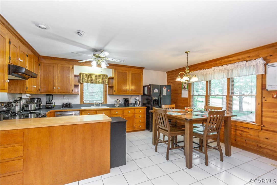 9901 Millers Run Road Chesterfield, VA 23236 - Photo 13 of 44 a dining hall with stainless steel appliances a dining table and chairs