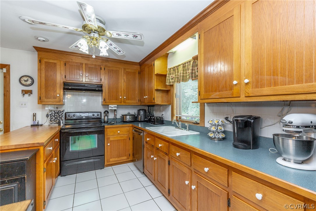9901 Millers Run Road Chesterfield, VA 23236 - Photo 15 of 44 a kitchen with stainless steel appliances granite countertop a sink counter space cabinets and a window