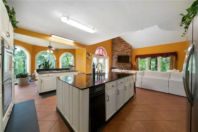 a large white kitchen with a large window