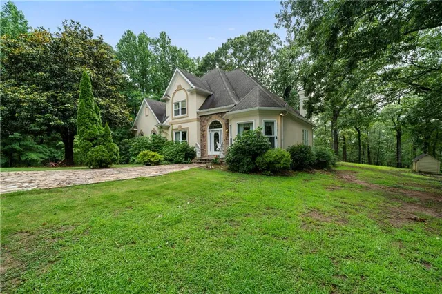 a front view of house with yard and green space