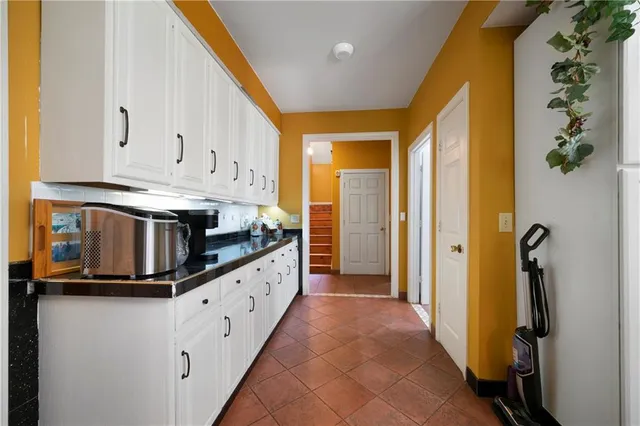 a kitchen with granite countertop a sink and a refrigerator