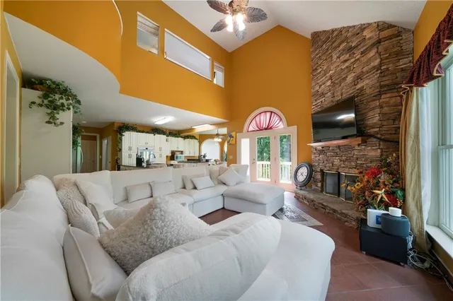 a living room with fireplace furniture and a chandelier