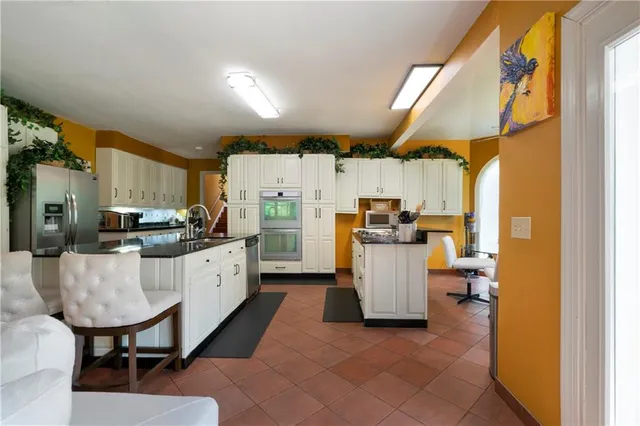 a large kitchen with a table and chairs