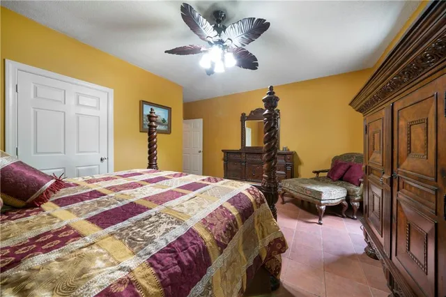 a bedroom with a bed and ceiling fan