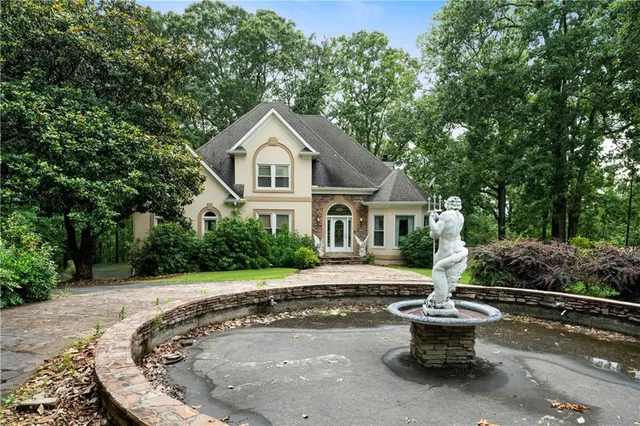 a front view of a house with sitting area