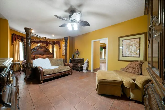 a bedroom with a bed couch and painting on the wall